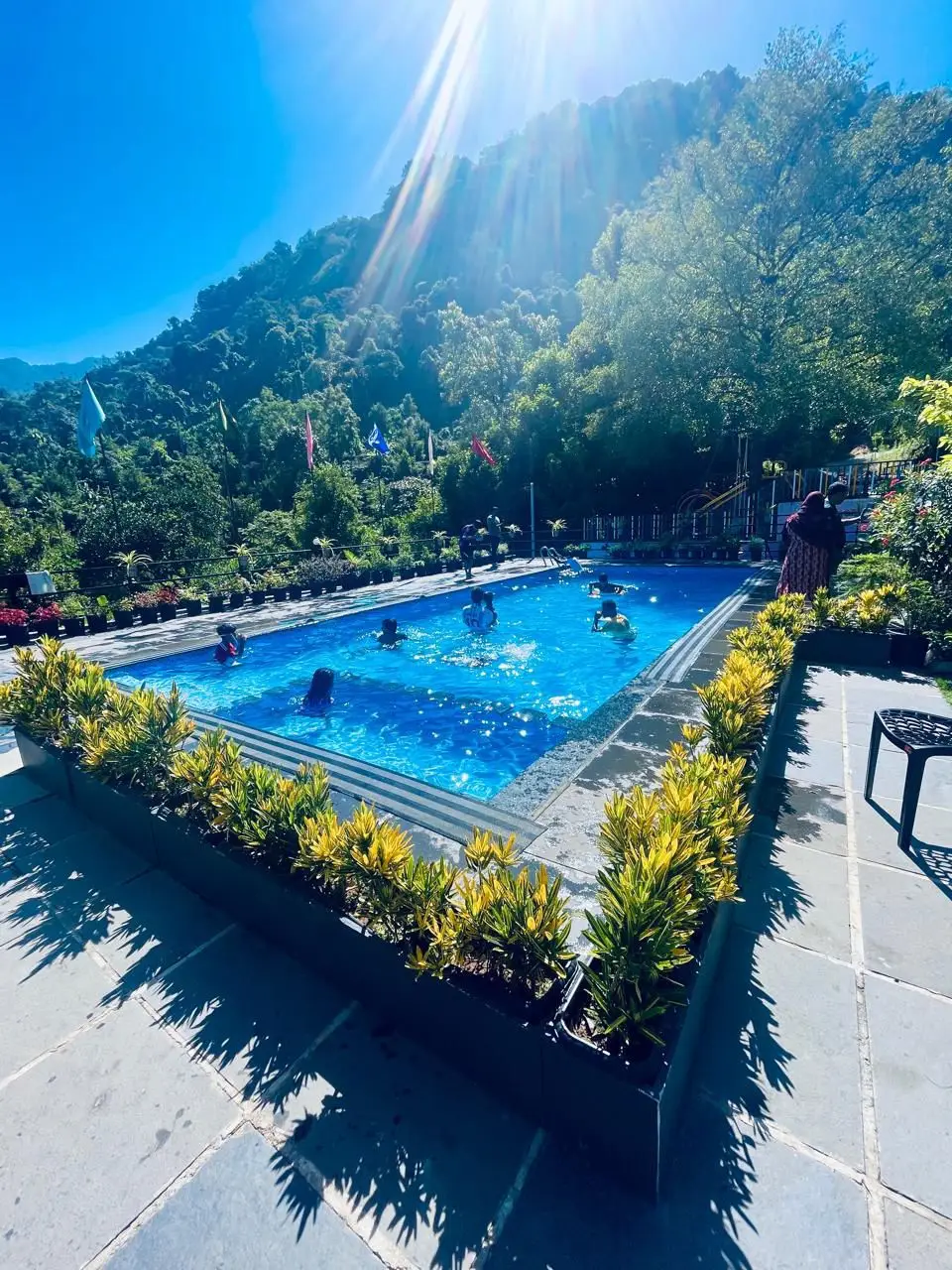 Family enjoying poolside at Mount 360 Resort, Poovaranthode, Kerala