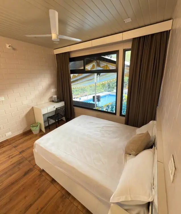 Comfortable guest room with pool view window